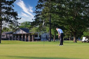 Golfer putting on practice putting green at Battle Ground Golf Club